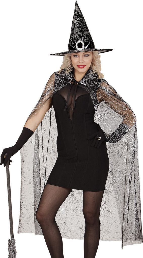 A woman wearing a witch costume, including a dress, cape, gloves, and hat, holding a broomstick.