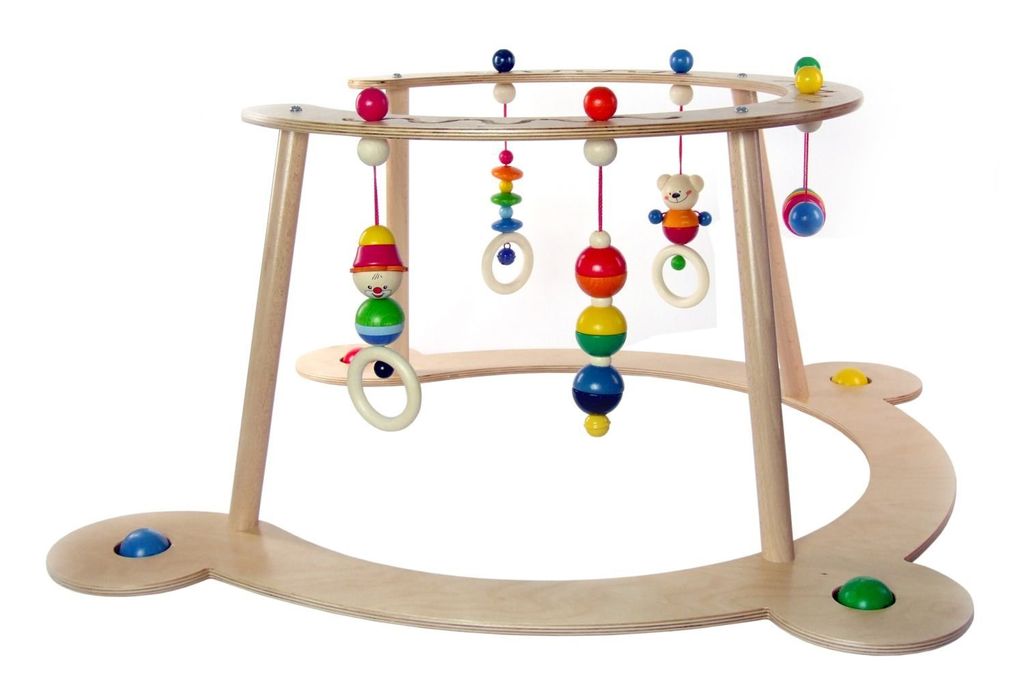 A wooden baby activity gym with hanging toys.