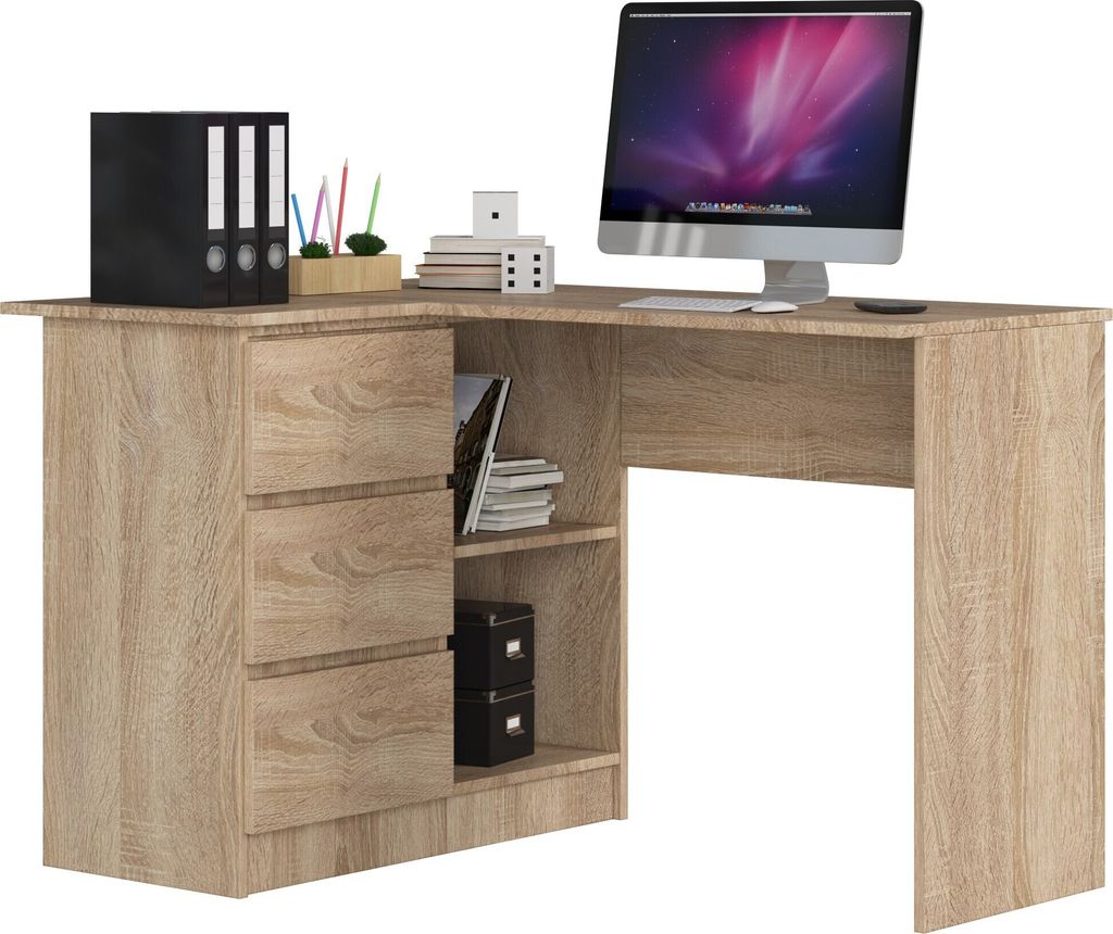 A corner desk with drawers and shelves, a computer monitor, and office supplies.