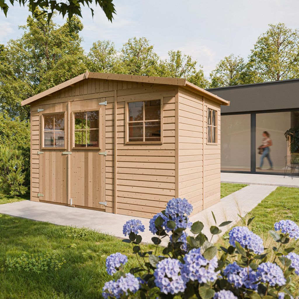 A wooden garden shed is shown in a backyard setting, with a modern house in the background and flowers in the foreground.