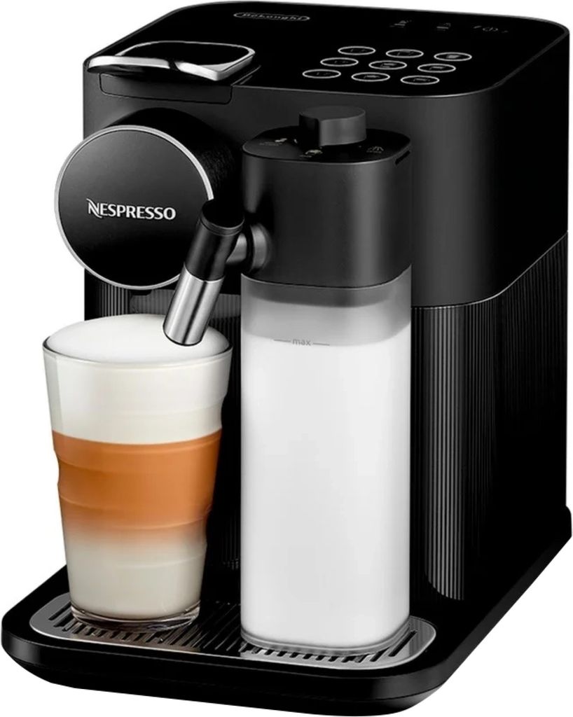 A black Nespresso coffee machine with a glass of latte and a milk carafe.