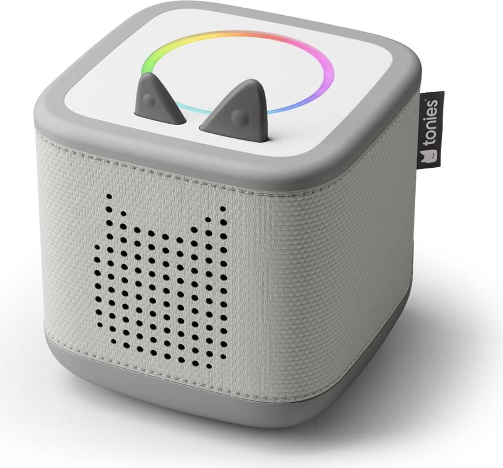 A gray and white Toniebox starter set with a rainbow light ring and cat ears.