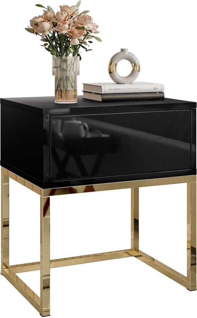 A black high-gloss nightstand with a gold-plated frame, decorated with a vase of flowers and books.
