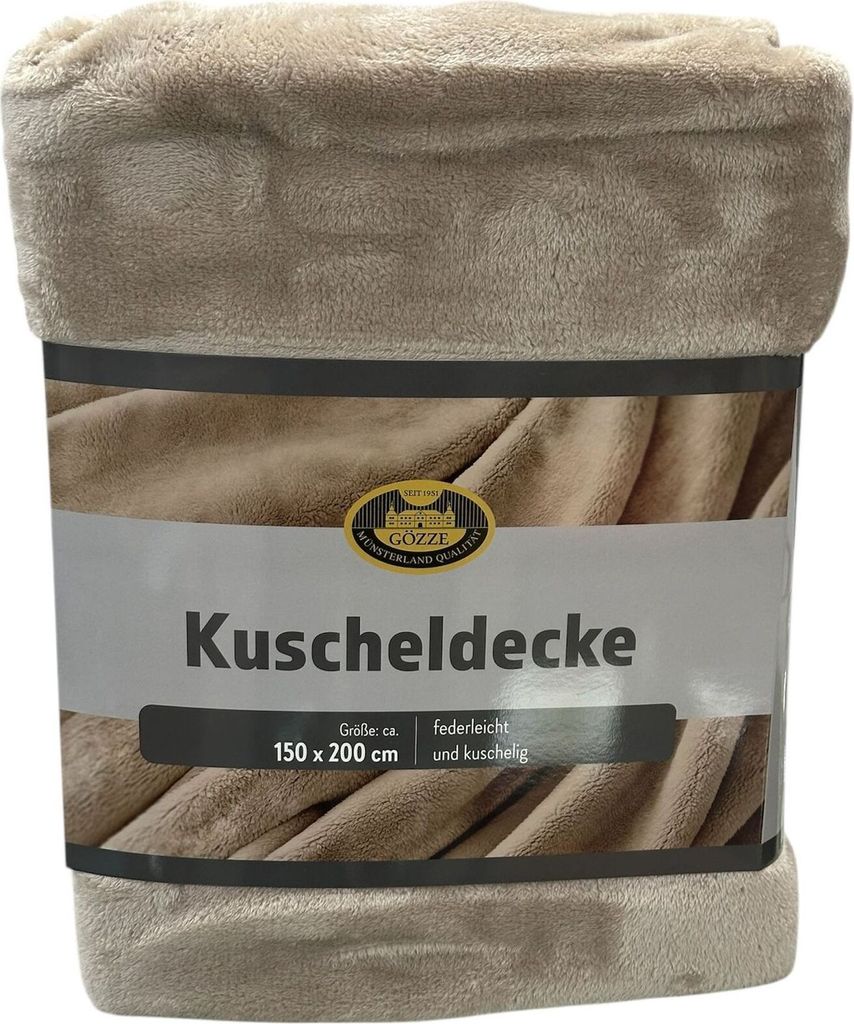A folded blanket with a product label.