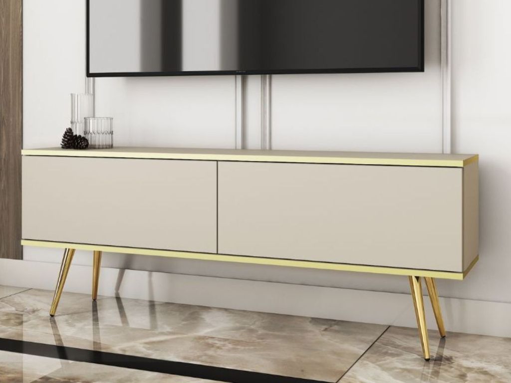 A modern TV stand with two doors and gold metal legs, placed in a living room setting.