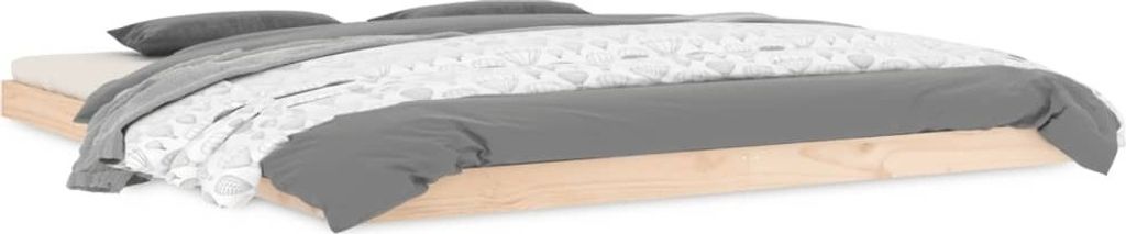 A bed with grey and white bedding on a wooden frame, viewed from the side.