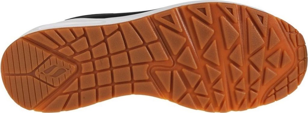 The underside of a black and white sneaker with a brown rubber sole.