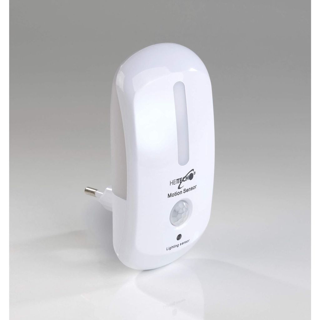 A white motion-activated LED night light with a motion sensor and light sensor, plugged into an outlet.