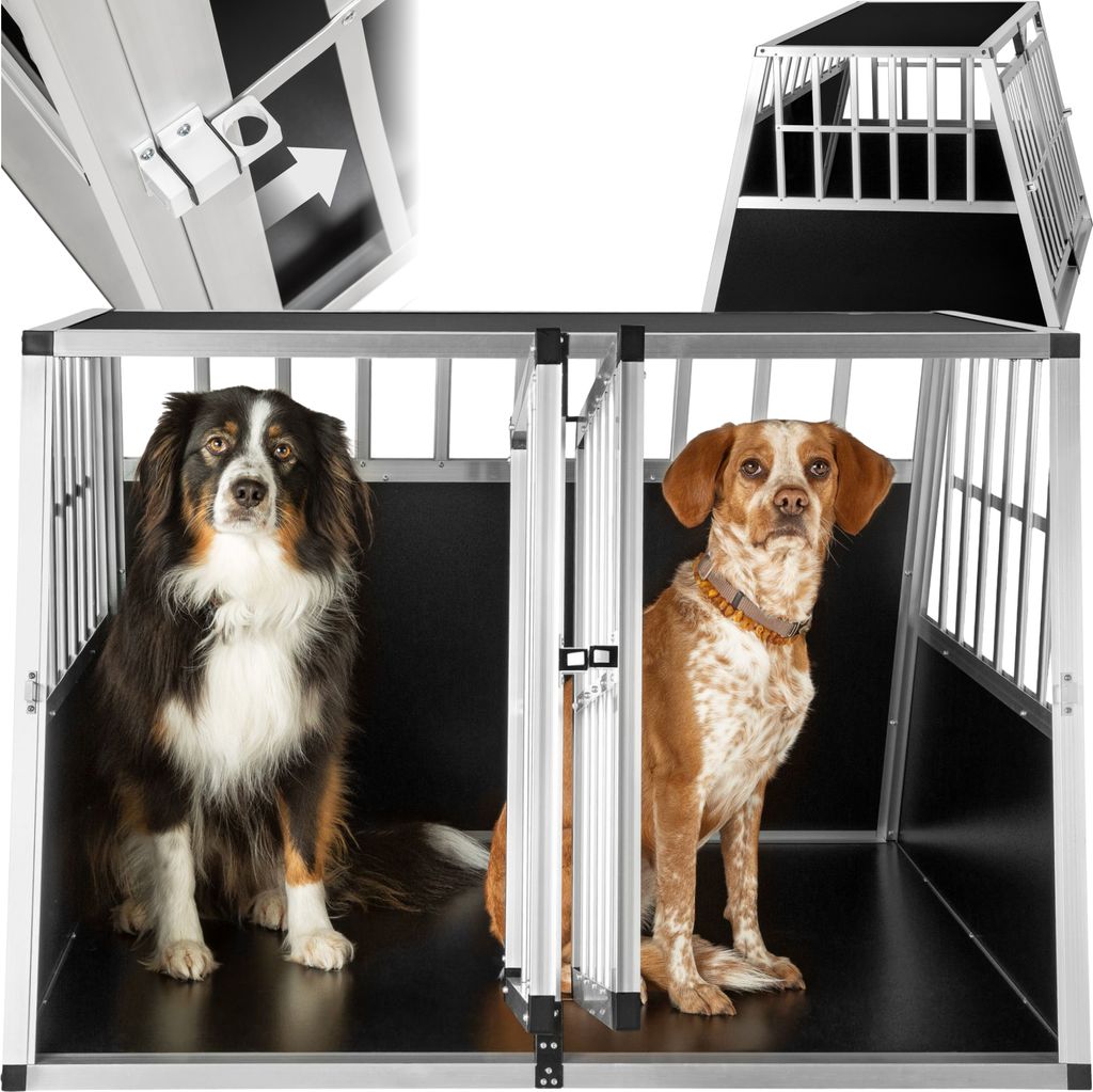 Two dogs are sitting in a double dog crate. The crate is made of metal bars and black panels. There are also inset images showing a close-up of the crate's latch and a smaller view of the crate.