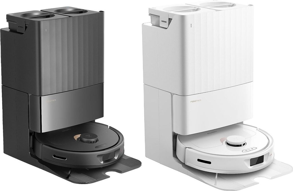 Two robot vacuum cleaners with docking stations, one white and one black, are displayed side-by-side against a white background.