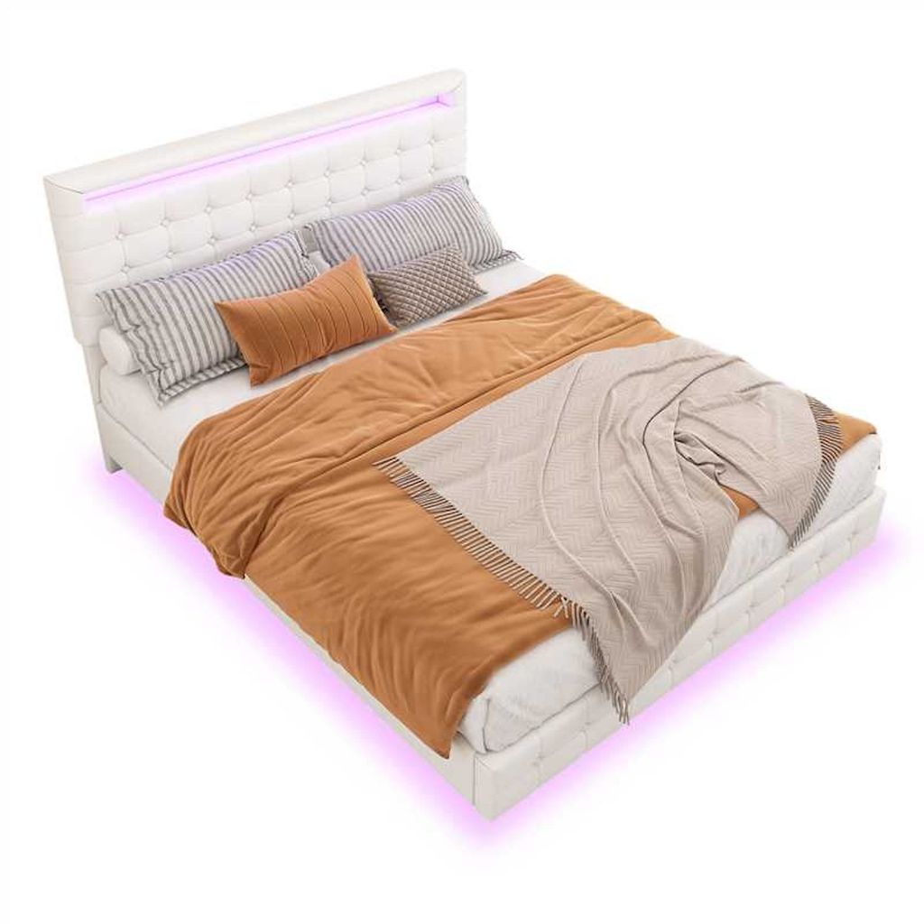 A white upholstered bed with a tufted headboard and LED lighting, dressed with bedding and pillows, shown from a diagonal angle.