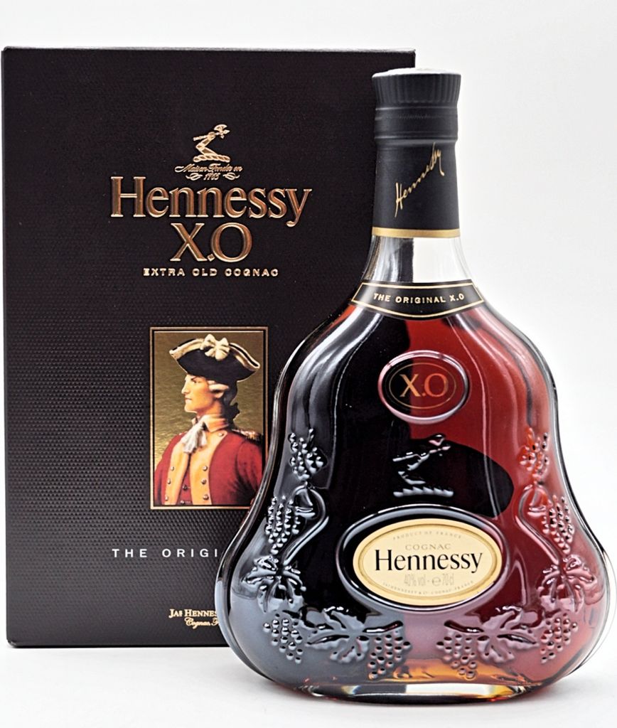 A bottle of Hennessy X.O. Extra Old Cognac and its gift box are displayed against a white background.