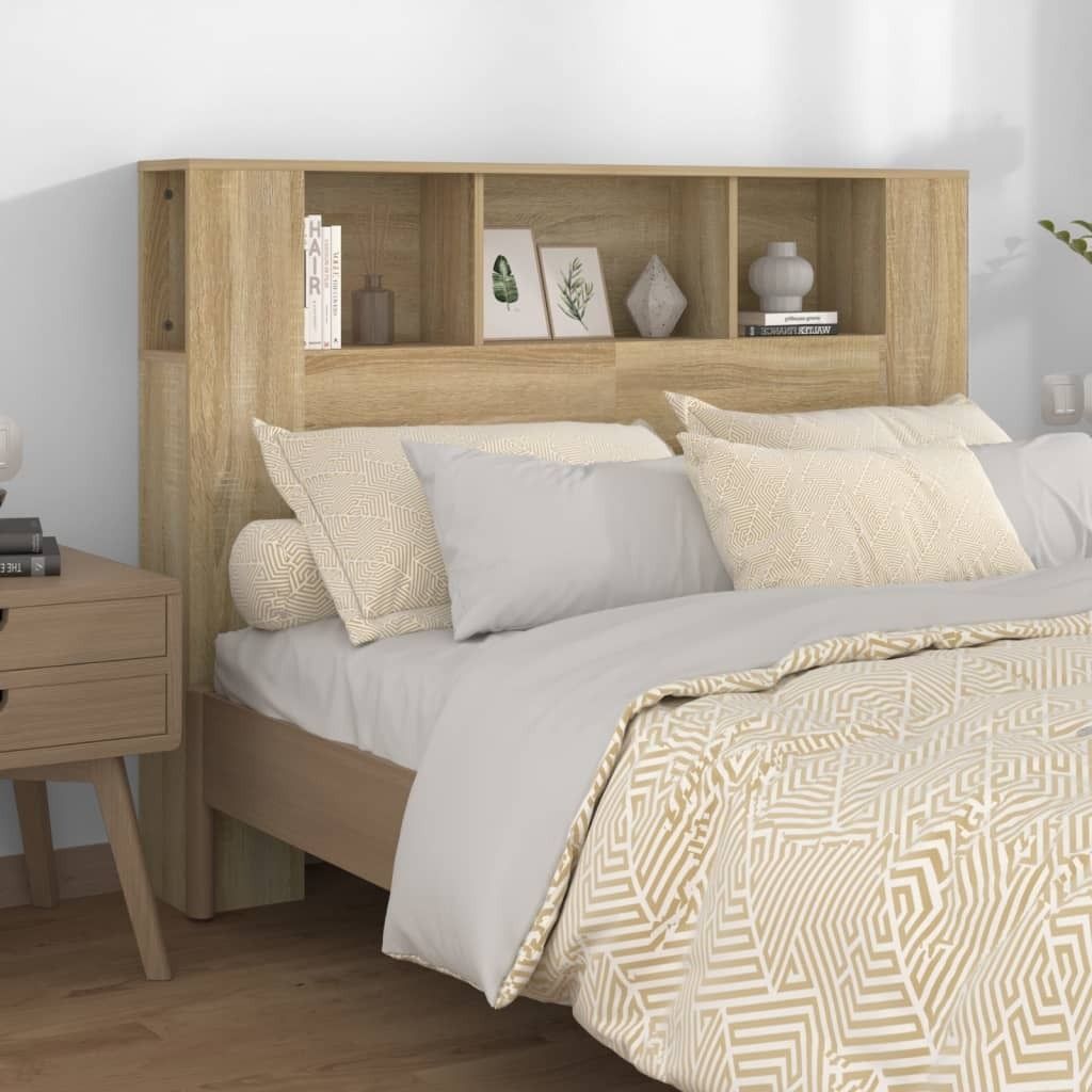 A bedroom scene with a bed and a headboard with shelves.