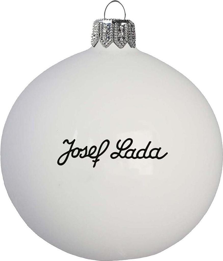 A white Christmas ornament with the signature "Josef Lada" written on it.