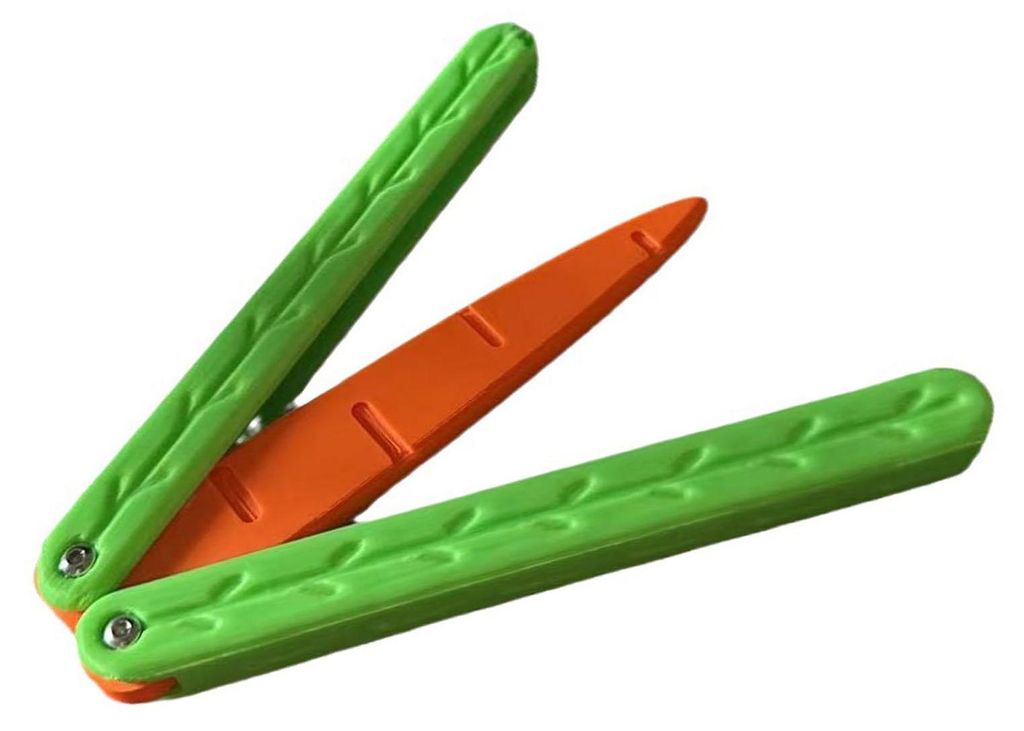 A toy knife shaped like a carrot, with green handles and an orange blade, is shown against a white background.