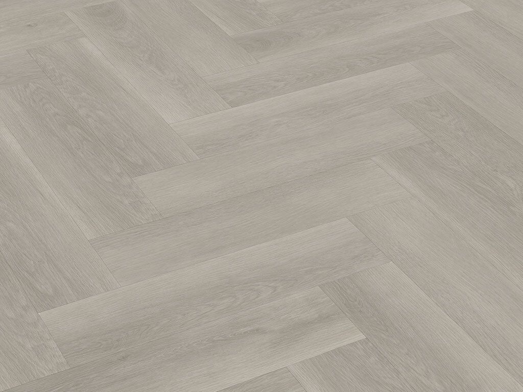 A close-up view of a light gray herringbone wood-look vinyl flooring.