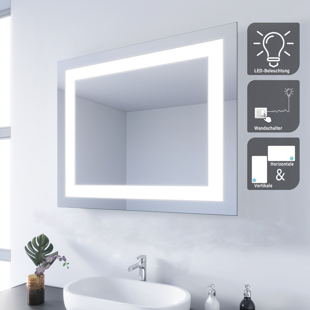 A bathroom scene with a mirror, sink, and faucet.