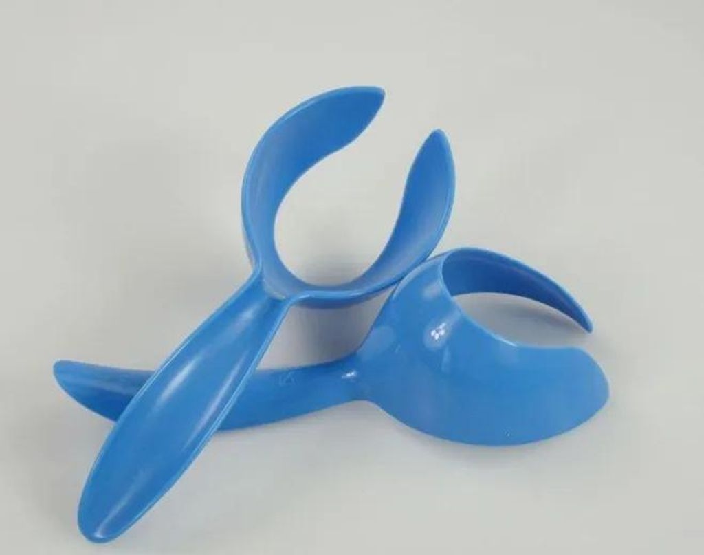 Two blue plastic kitchen utensils are placed on a white background.