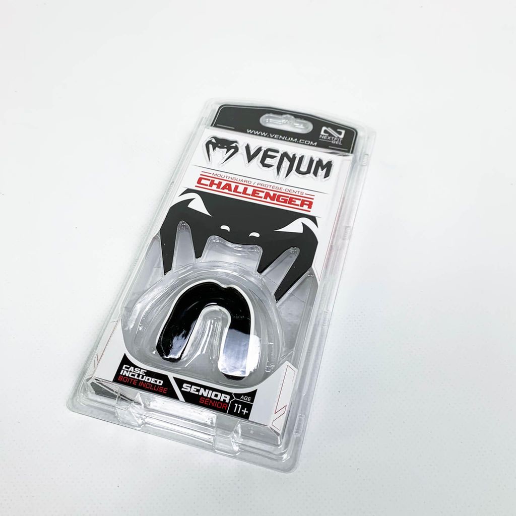 A Venum Challenger mouthguard is shown in its clear plastic packaging against a white background.