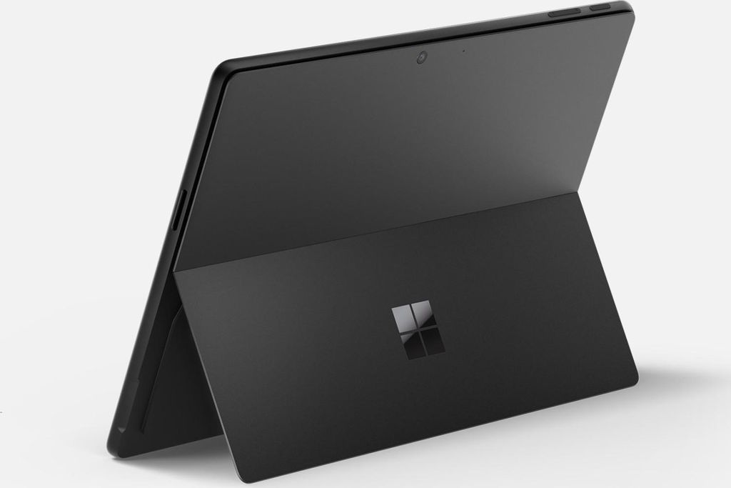 A black Microsoft Surface Pro tablet is shown from a rear-facing, slightly angled perspective, standing on its kickstand against a light gray background.