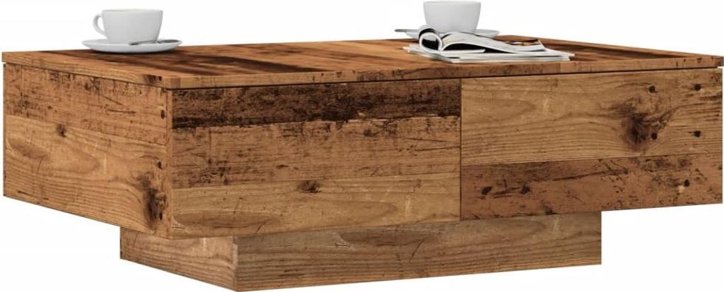 A wooden coffee table with two cups and a magazine on top, set against a white background.