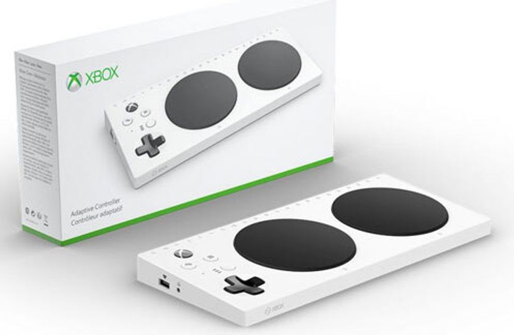 A white Xbox Adaptive Controller and its packaging are displayed on a white background.