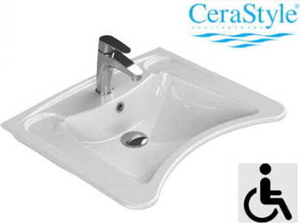 A white ceramic sink with a chrome faucet and drain is shown against a white background. A logo and an accessibility symbol are present.