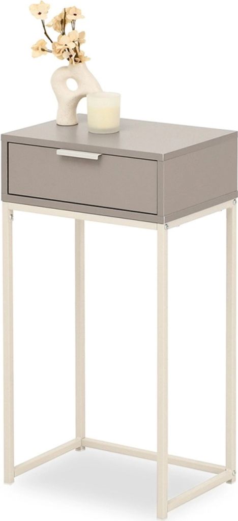 A narrow console table with a drawer and a decorative vase with flowers and a candle on top.