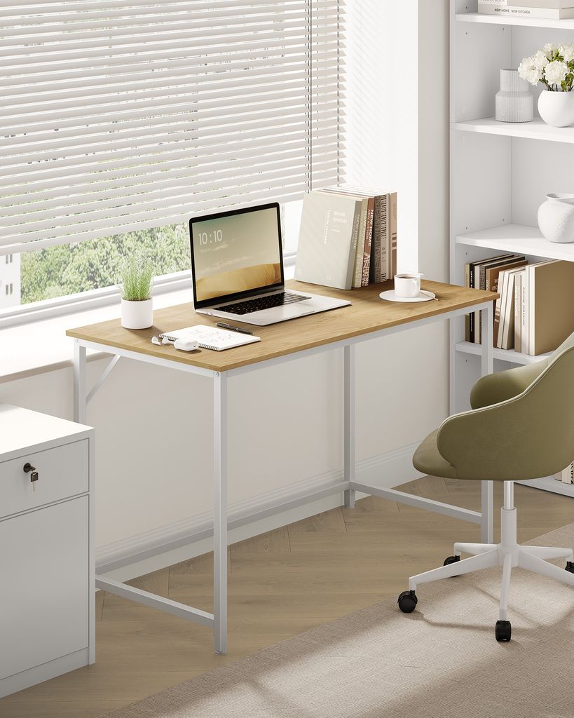 A home office setup with a desk, laptop, chair, and bookshelf.