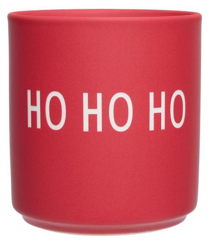 A red mug with white text.