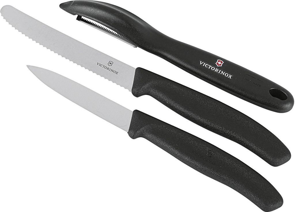 A set of three kitchen knives and a peeler against a white background.