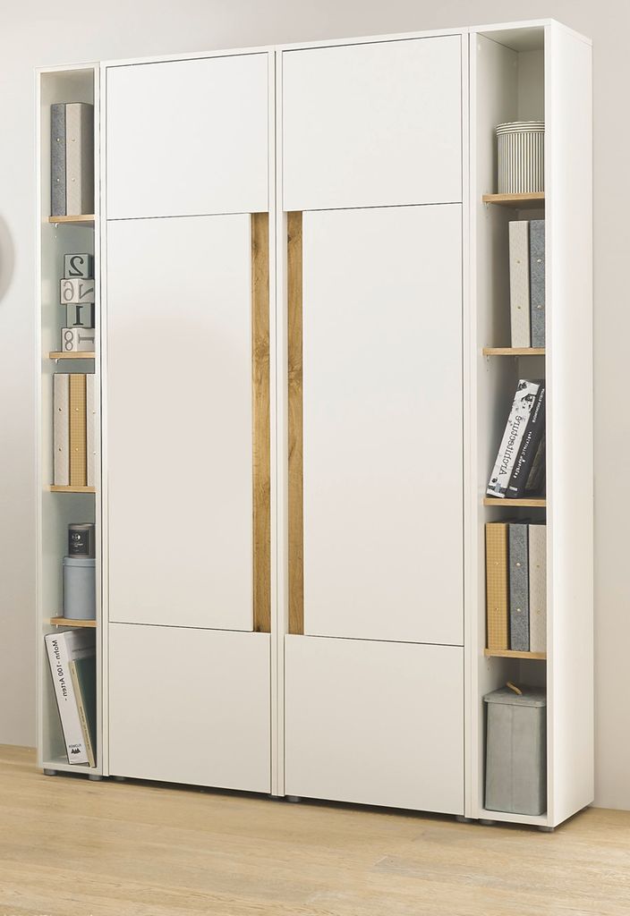 A white wardrobe with wood accents and shelves filled with books and decorative items.