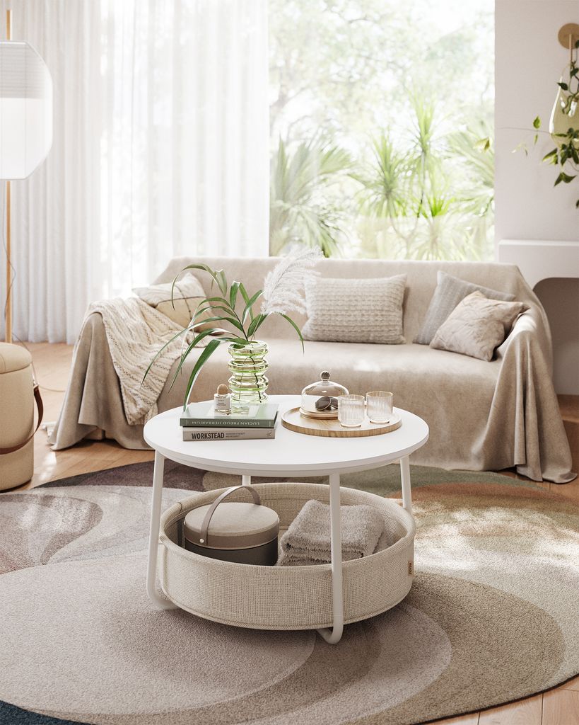 A living room scene with a sofa, coffee table, and rug.