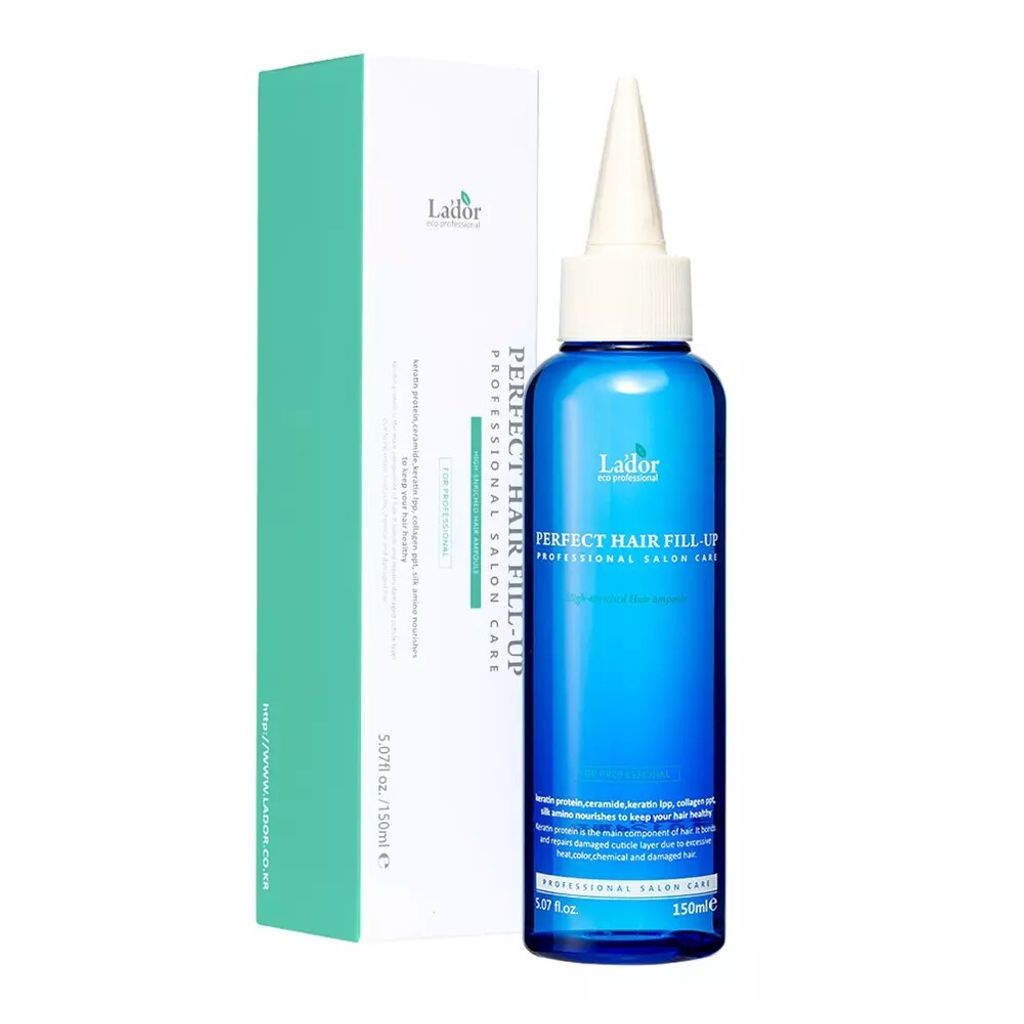 A product shot of a bottle of hair treatment next to its packaging.