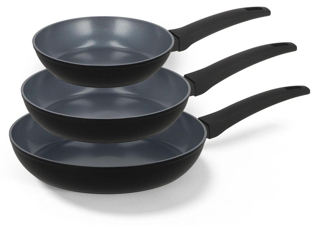 Three black frying pans stacked on top of each other.