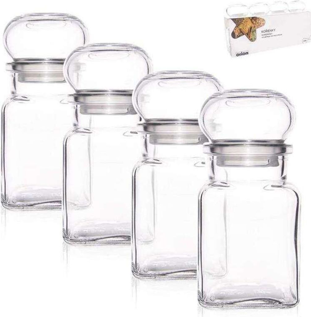 Four clear glass spice jars with silver lids are arranged in a row on a white background. A small box with product information is in the upper right corner.