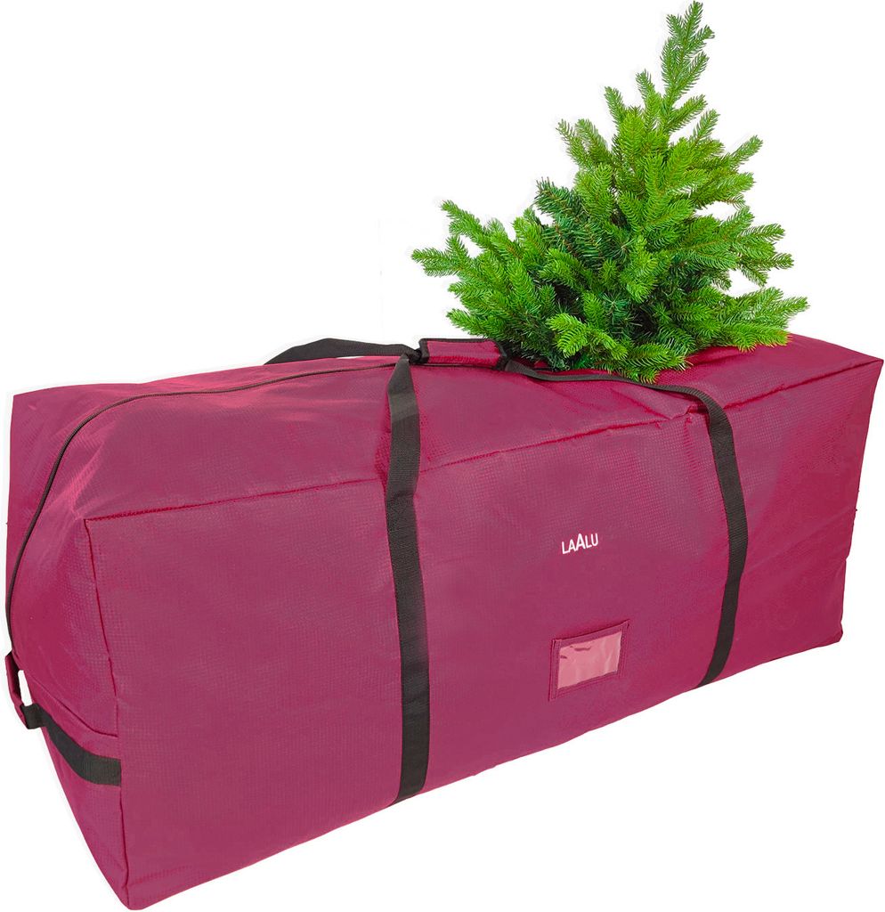 A maroon Christmas tree storage bag with a small artificial tree on top.