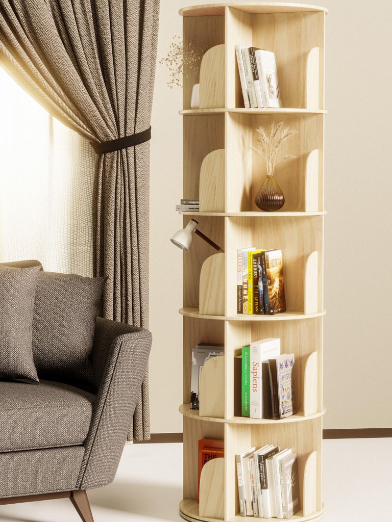 A rotating bookshelf filled with books and decorative items is placed next to a sofa and a curtained window.
