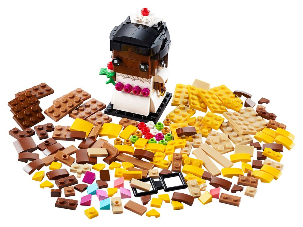 A LEGO BrickHeadz bride figure surrounded by loose LEGO bricks of various colors and shapes.