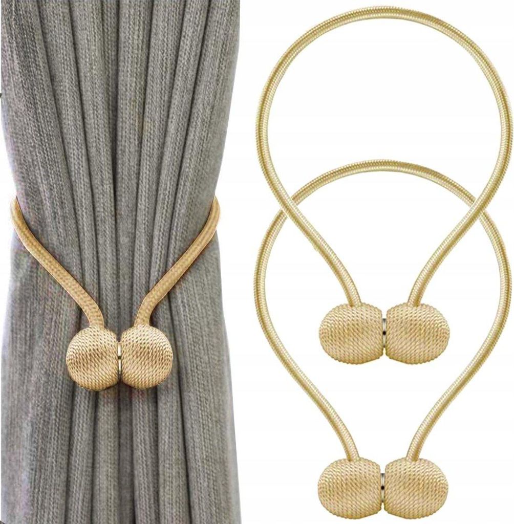 A product image showing two magnetic curtain clips, one attached to a grey curtain and another shown separately.