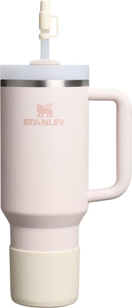 A pink Stanley Quencher tumbler with a straw and a cream-colored boot.