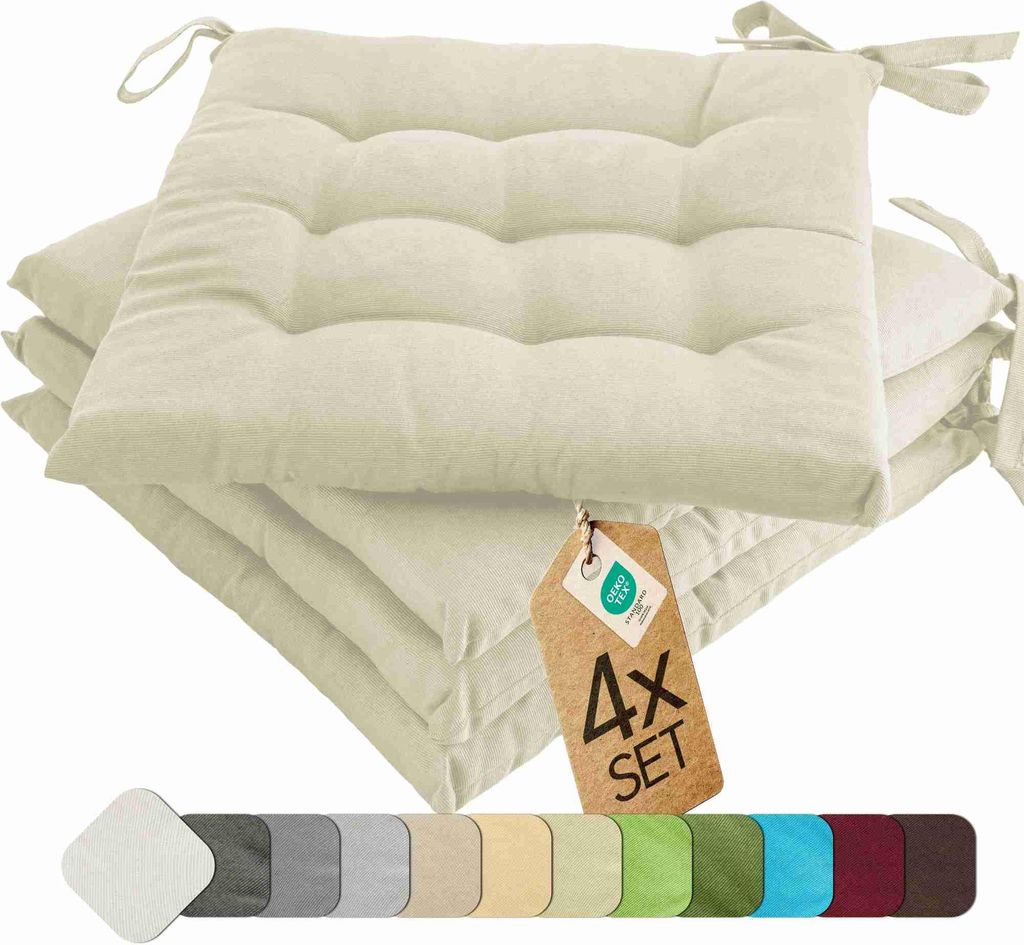 A stack of cream-colored seat cushions with ties, a product tag, and a color swatch strip.