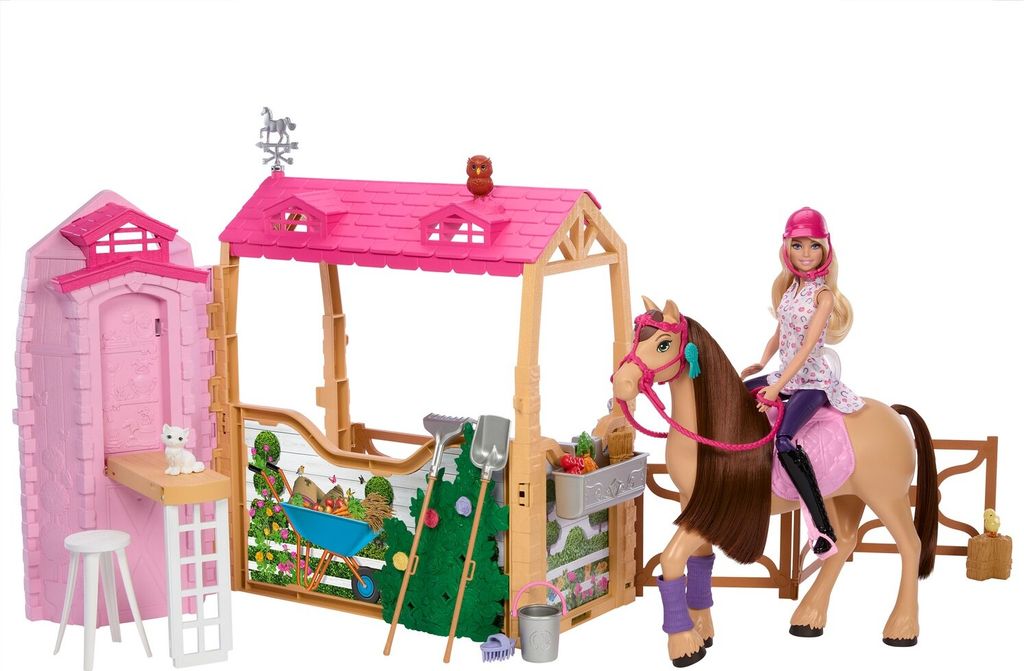 A Barbie doll on a horse in front of a stable playset.