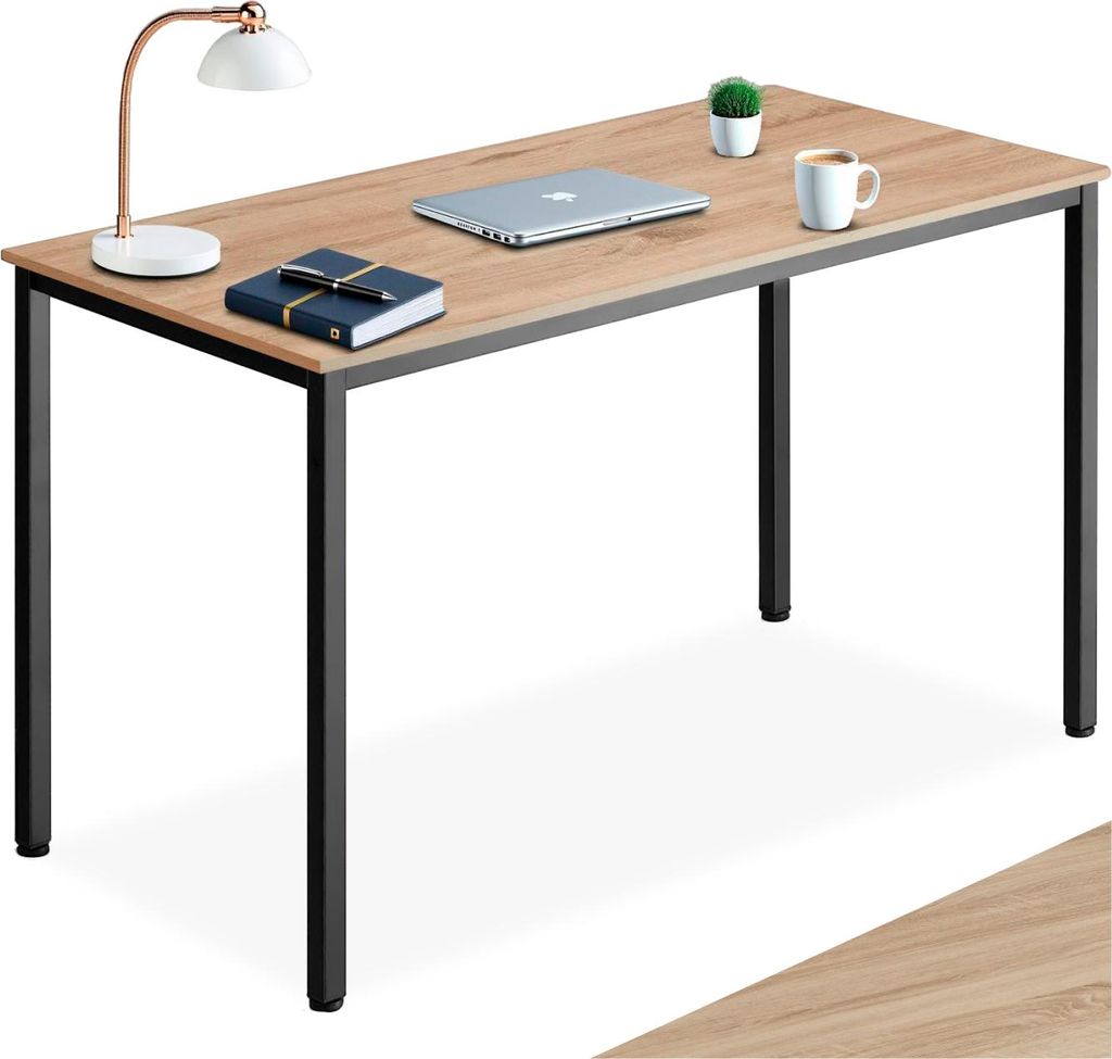 A desk with a laptop, lamp, notebook, pen, and mug.