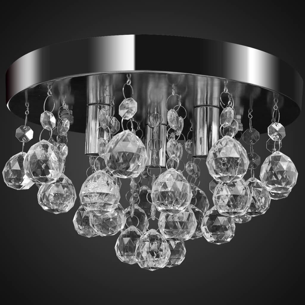 A close-up studio shot of a crystal chandelier with a chrome finish against a black background.