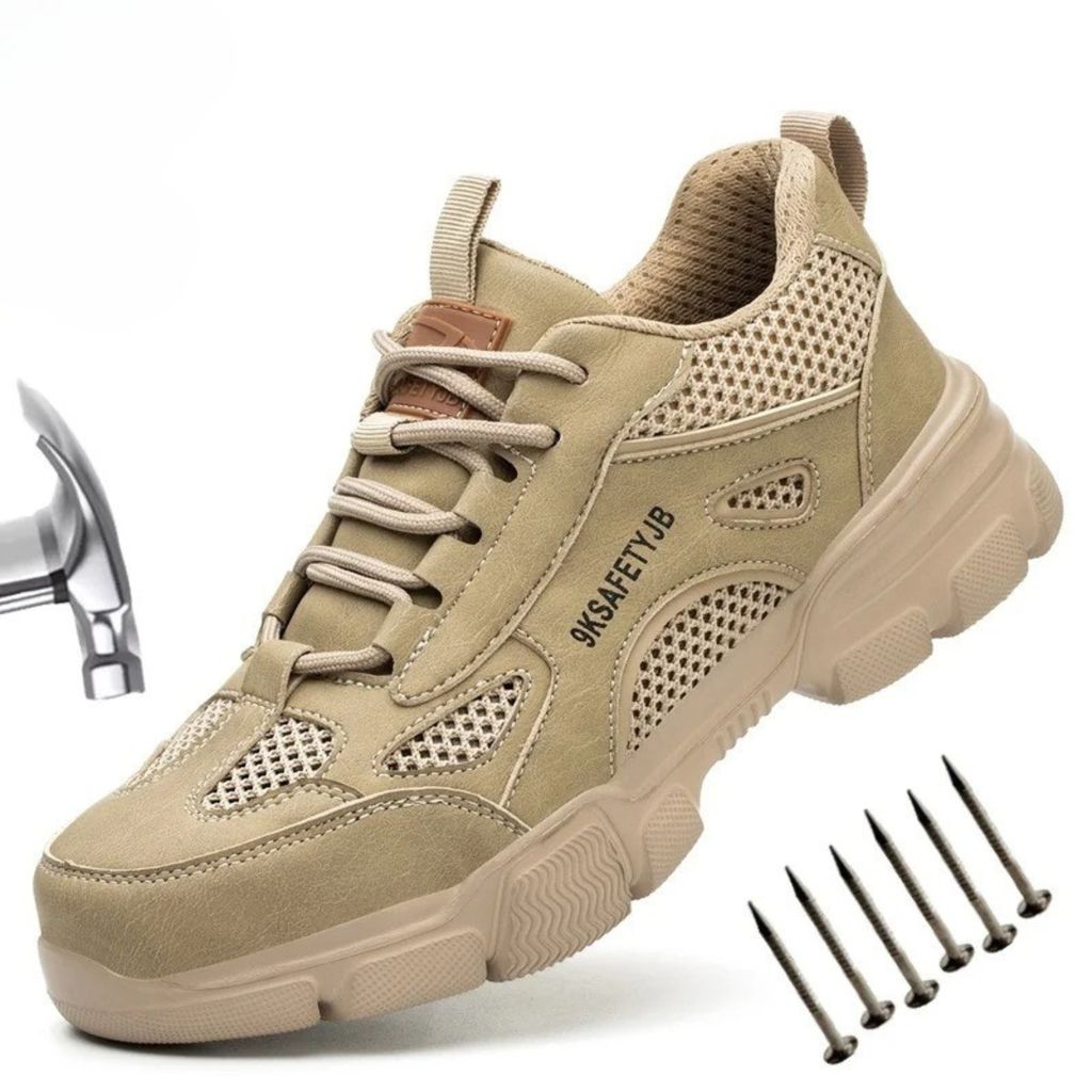 A single tan safety shoe is shown on a white background, with a hammer and nails placed around it to illustrate its protective features.