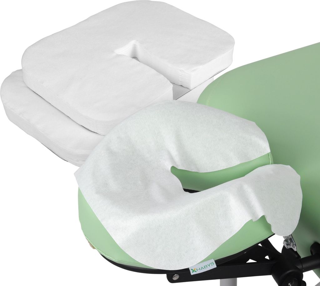 A close-up view of disposable face cradle covers on a massage table.