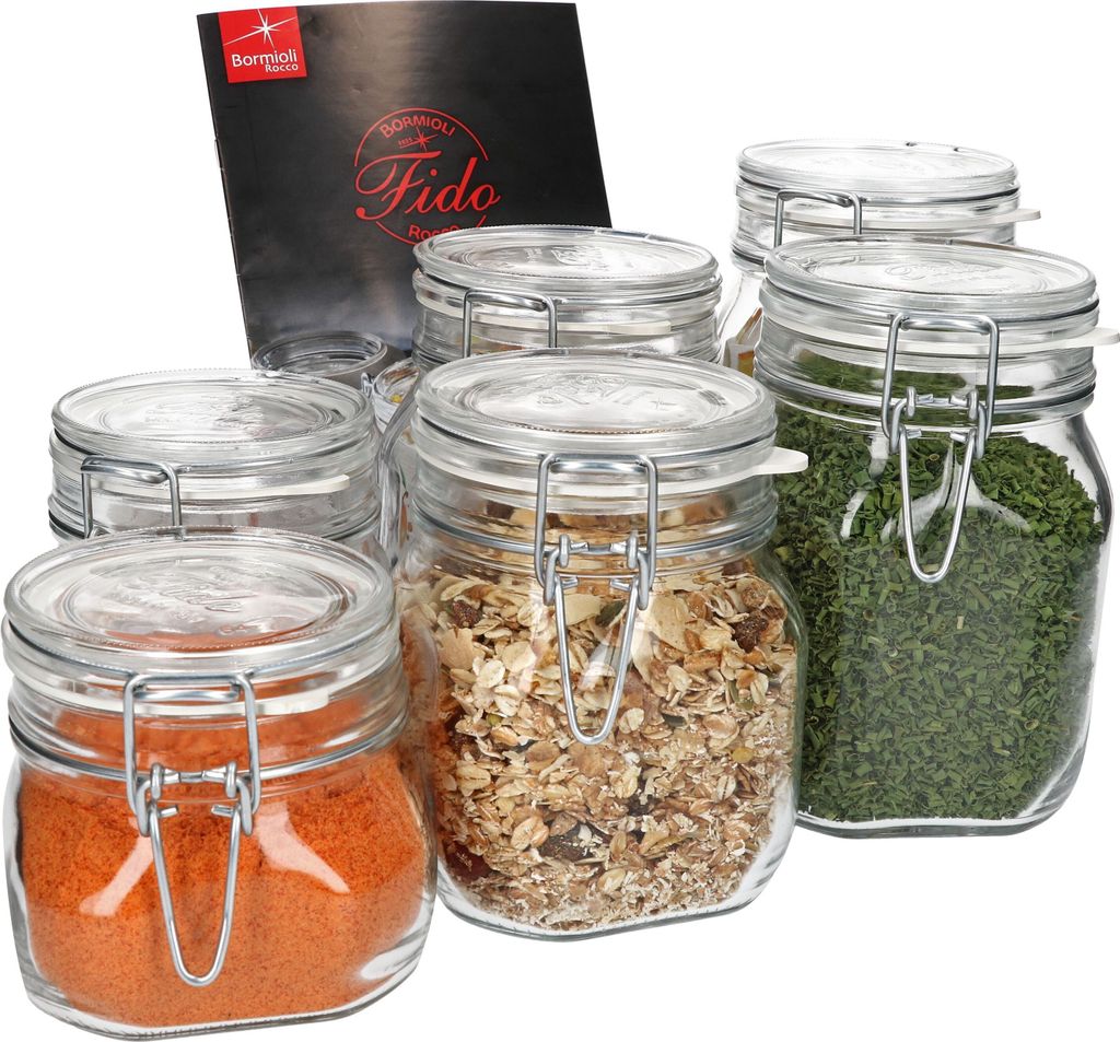 A set of glass jars with metal clasps and lids, some filled with food items, and a product information card.