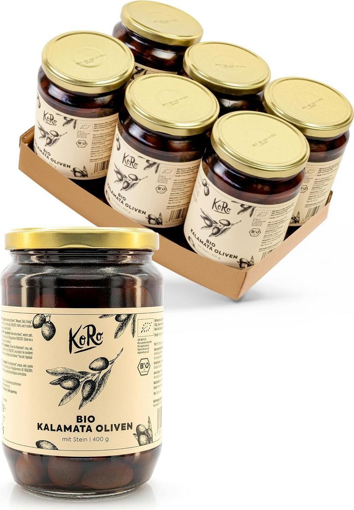A close-up view of a single jar of Kalamata olives in the foreground, with a cardboard box containing six jars of olives in the background.