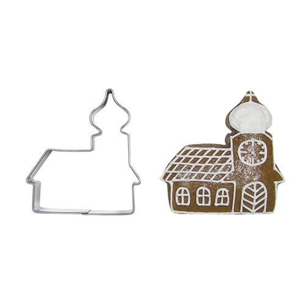 A metal cookie cutter shaped like a church and a gingerbread cookie made with the cutter.